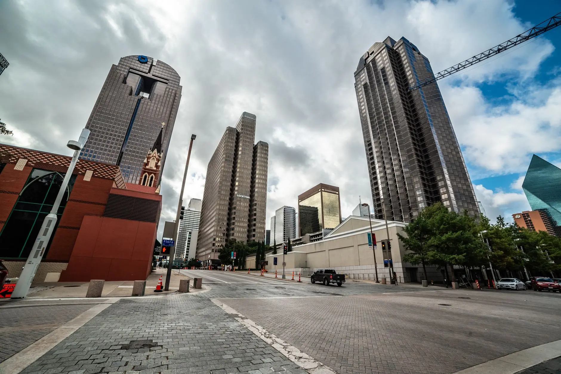 Explore the modern skyline of downtown Dallas, Texas with towering skyscrapers under a dramatic sky.